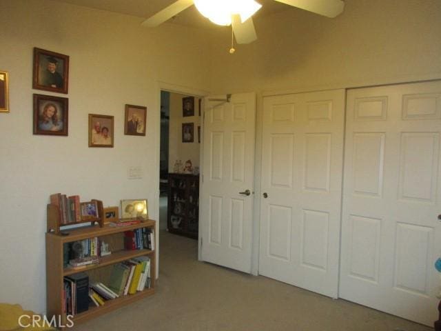 bedroom with a ceiling fan, a closet, and carpet flooring