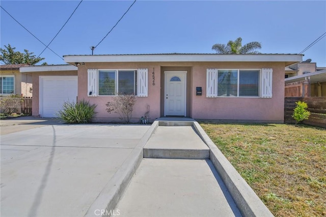 view of front of house featuring a garage and a front lawn