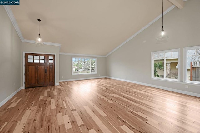 foyer featuring high vaulted ceiling, ornamental molding, and light hardwood / wood-style floors