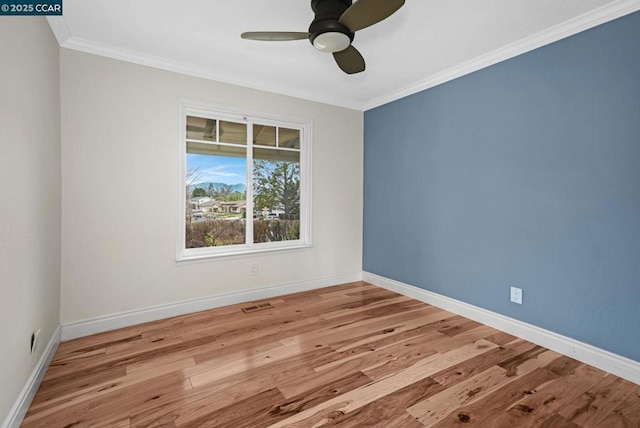 spare room with crown molding, ceiling fan, and light hardwood / wood-style flooring