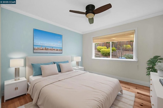 bedroom with crown molding, light hardwood / wood-style floors, and ceiling fan