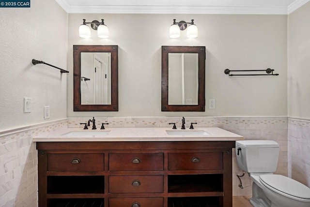 bathroom featuring vanity, ornamental molding, tile walls, and toilet