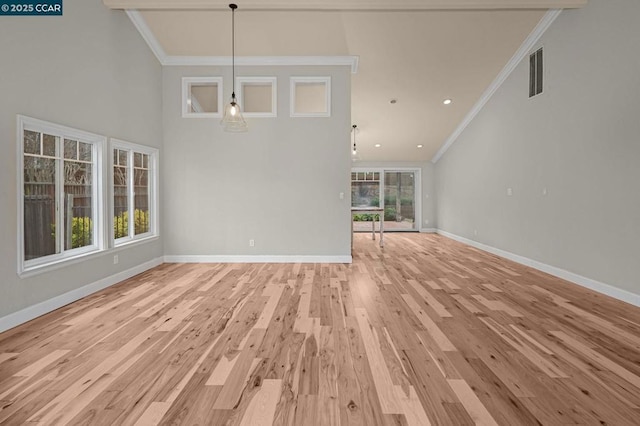 interior space with crown molding, a high ceiling, and light wood-type flooring