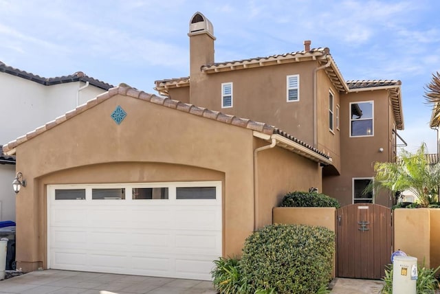 mediterranean / spanish home featuring a garage