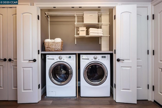 laundry room featuring dark hardwood / wood-style floors and washing machine and dryer