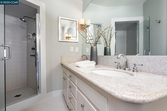 bathroom featuring walk in shower and vanity