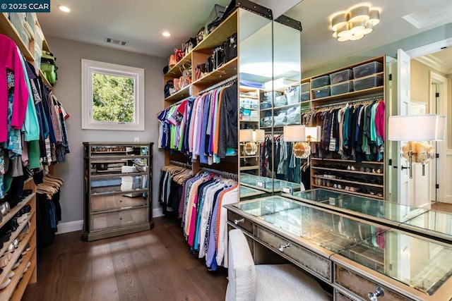 walk in closet with dark wood-type flooring