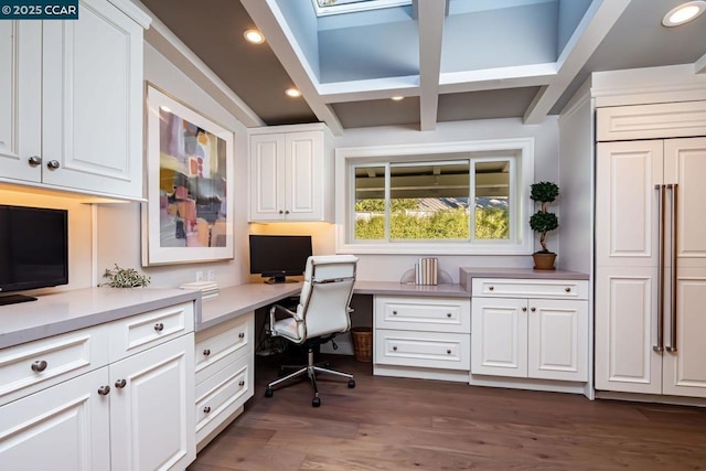 office with dark wood-type flooring and built in desk