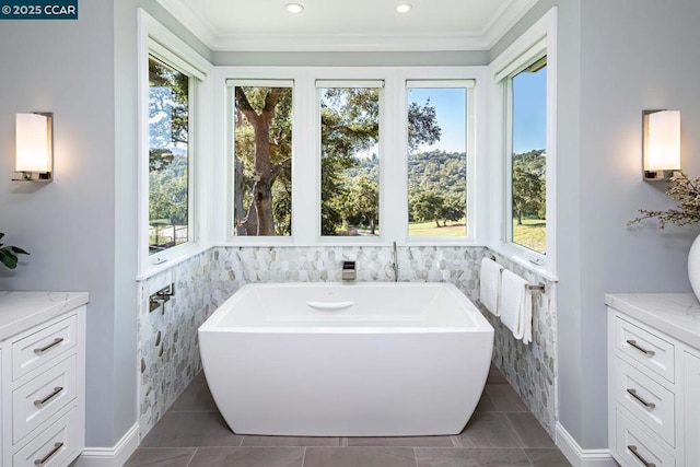 bathroom with vanity, tile patterned flooring, and a tub