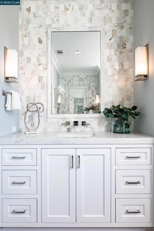 bathroom featuring crown molding and vanity