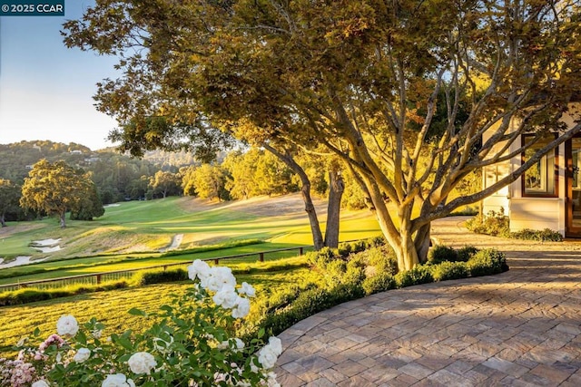 view of property's community with a patio and a yard