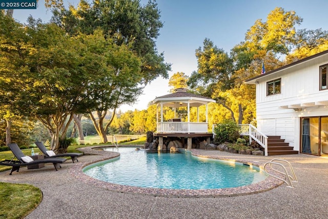 view of pool with a gazebo, a deck, and a patio area