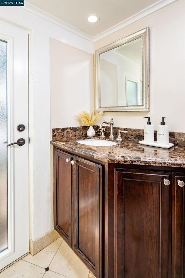 bathroom with ornamental molding, vanity, and tile patterned floors