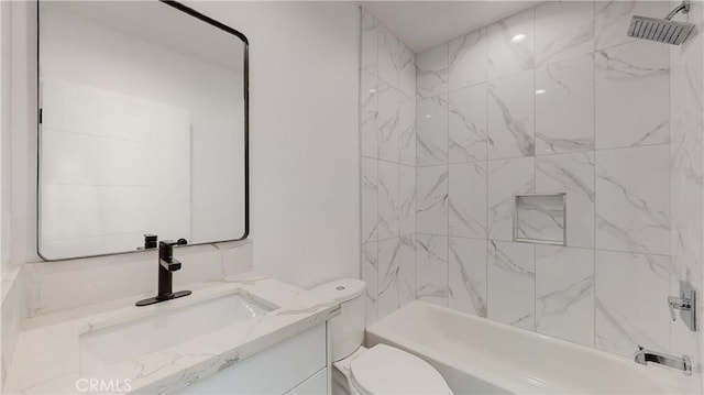 full bathroom with vanity, tiled shower / bath combo, and toilet