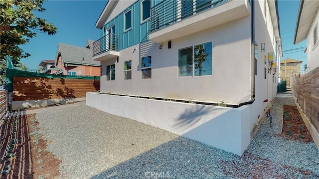 view of side of property featuring a balcony