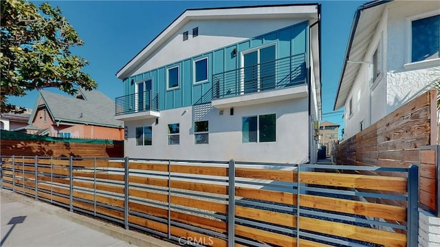 236 N Burlington, Los Angeles, CA 90026 - view of home's exterior with stucco siding, a balcony, and board and batten siding