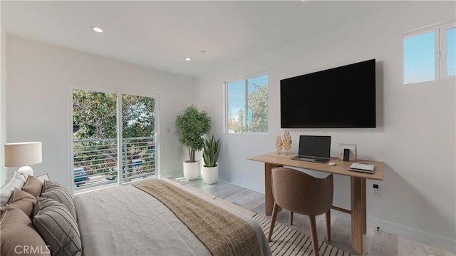 bedroom featuring light hardwood / wood-style flooring and access to outside