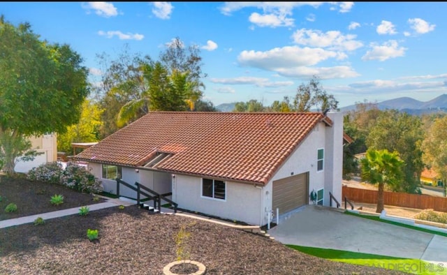 view of front facade with a mountain view and a garage