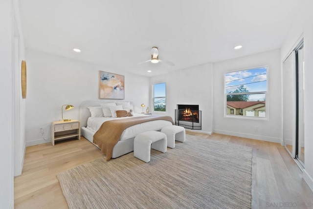 bedroom featuring ceiling fan and light hardwood / wood-style flooring