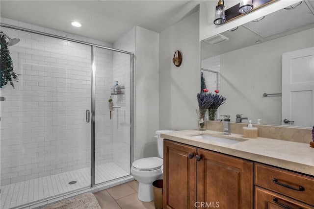 bathroom with vanity, a shower with shower door, tile patterned floors, and toilet