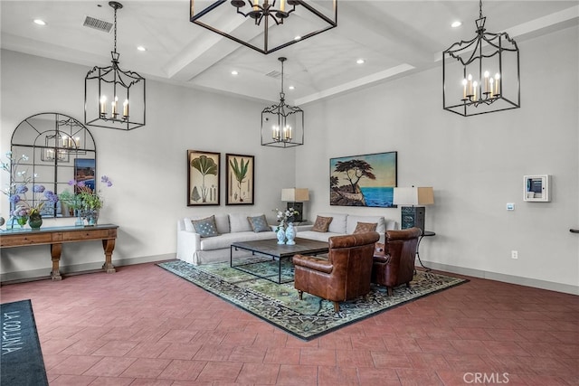 living room featuring beamed ceiling and a chandelier