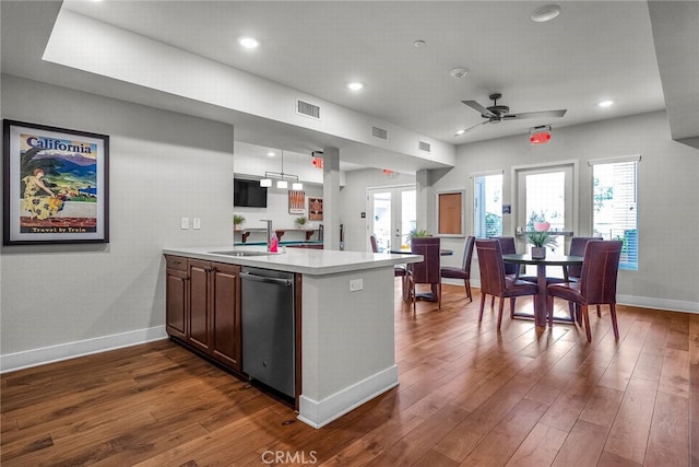 kitchen with french doors, dishwasher, sink, and kitchen peninsula