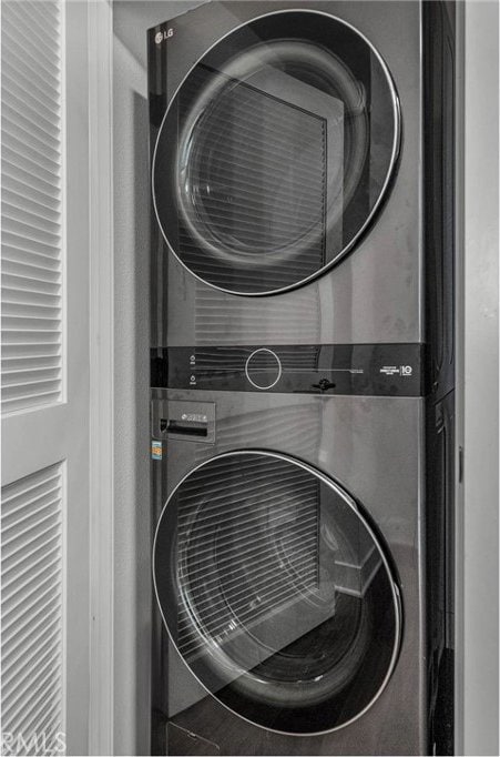 laundry area with stacked washer and dryer