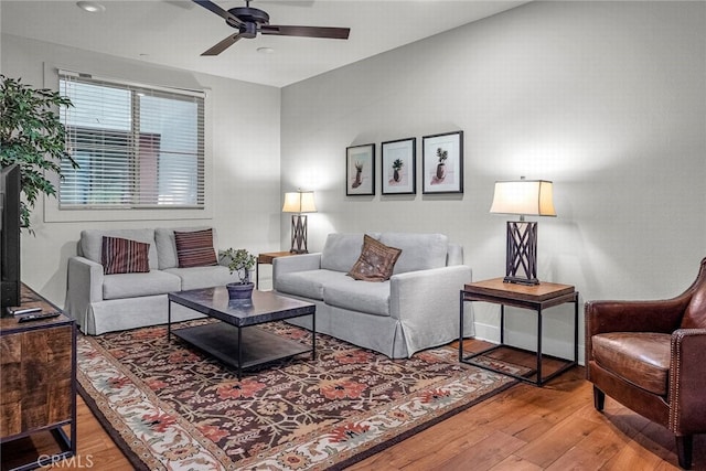 living room featuring hardwood / wood-style flooring and ceiling fan