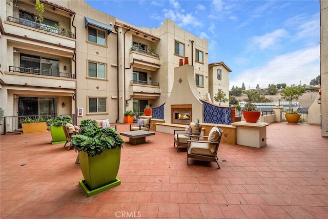 view of patio / terrace with an outdoor fireplace