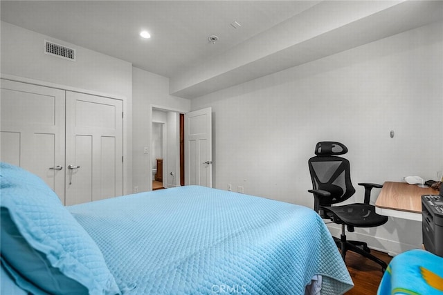 bedroom featuring dark hardwood / wood-style floors and a closet