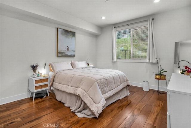 bedroom with dark hardwood / wood-style floors