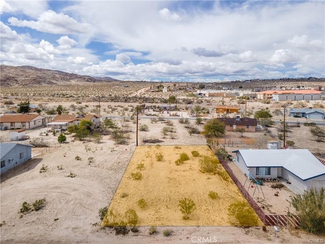 birds eye view of property with a mountain view