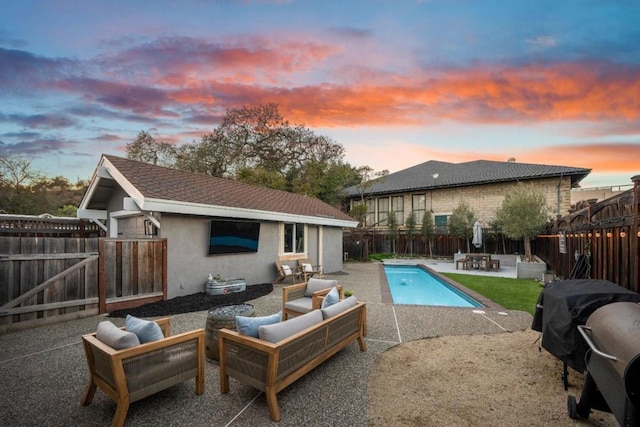 pool at dusk featuring a grill, an outdoor living space, and a patio