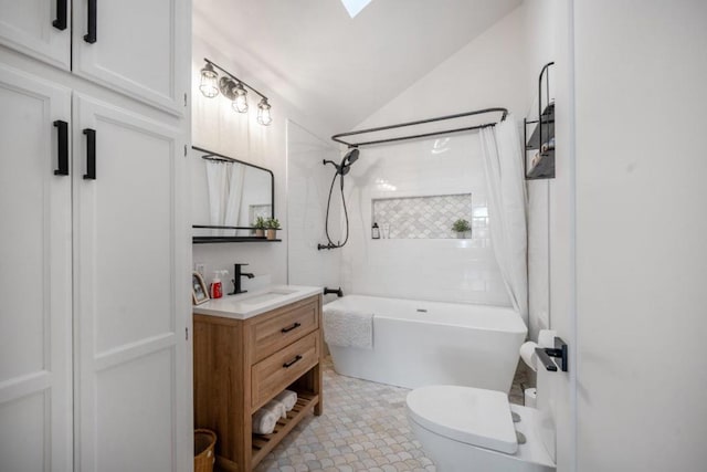 full bathroom with vanity, lofted ceiling, tiled shower / bath, and toilet