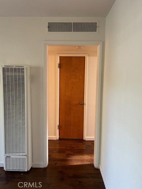 hallway featuring dark hardwood / wood-style floors