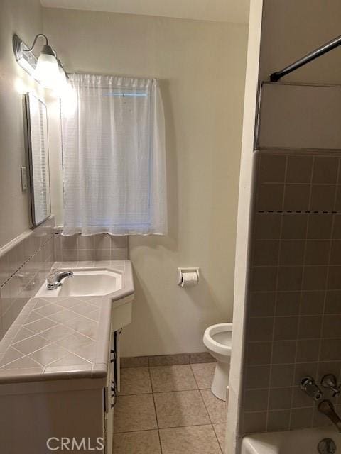 full bathroom with tile patterned flooring, vanity, shower / bathtub combination, and toilet