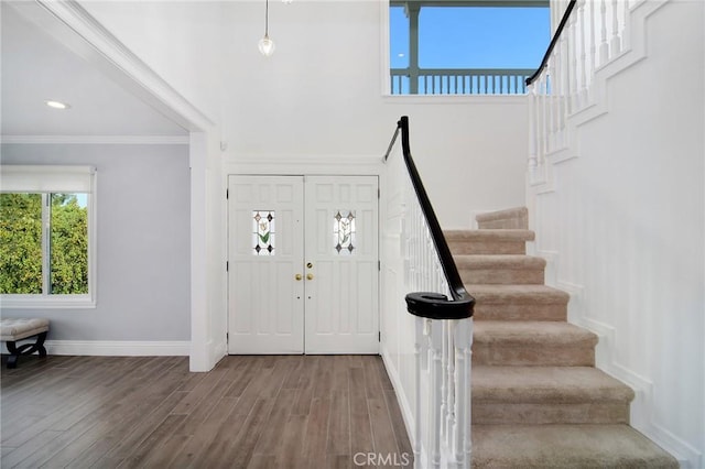 entrance foyer featuring crown molding and hardwood / wood-style floors