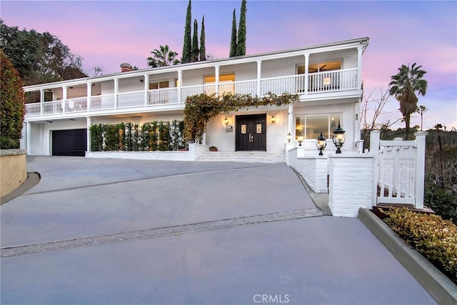 view of front of house with a garage and a balcony