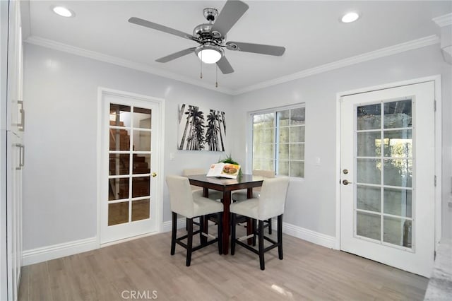 dining room with crown molding, light hardwood / wood-style flooring, and ceiling fan