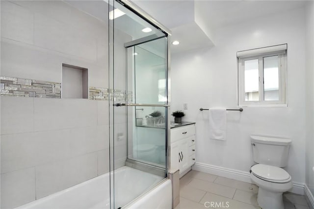 bathroom featuring tile patterned floors, toilet, and combined bath / shower with glass door