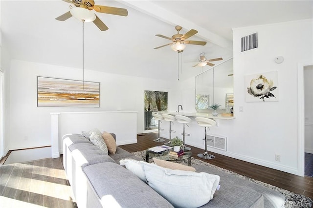 living room with beam ceiling, dark wood-type flooring, and high vaulted ceiling