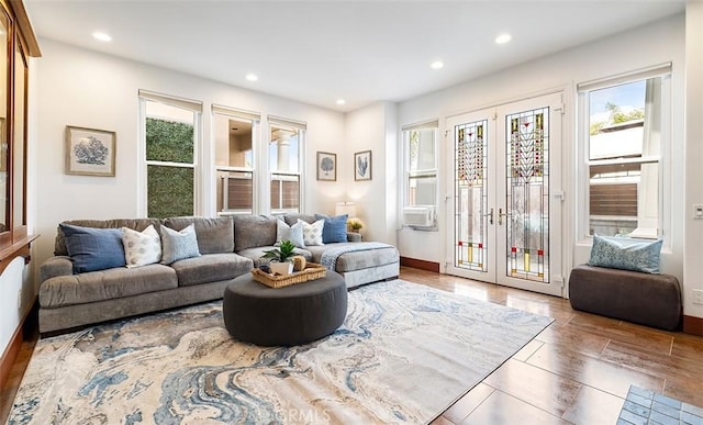 living area with recessed lighting, plenty of natural light, baseboards, and french doors