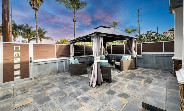 view of patio / terrace with a fenced backyard, outdoor lounge area, and a gazebo