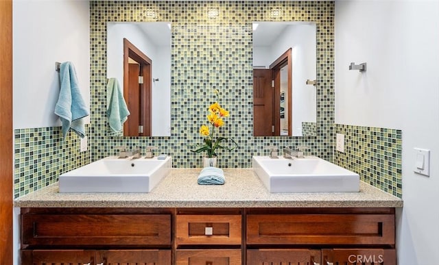 full bathroom with a sink, decorative backsplash, and double vanity