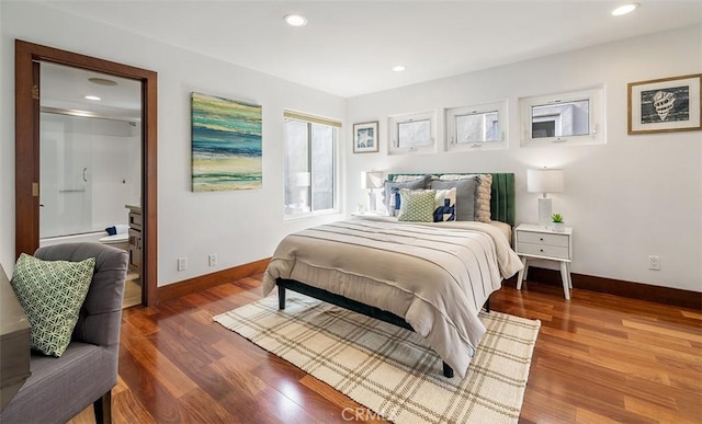 bedroom with baseboards, wood finished floors, and recessed lighting