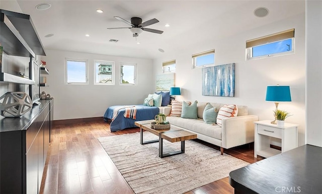 living area with visible vents, wood finished floors, a ceiling fan, and recessed lighting