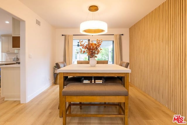 dining space with light hardwood / wood-style flooring