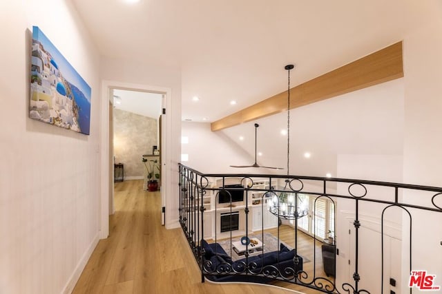 hallway featuring vaulted ceiling with beams and light hardwood / wood-style floors