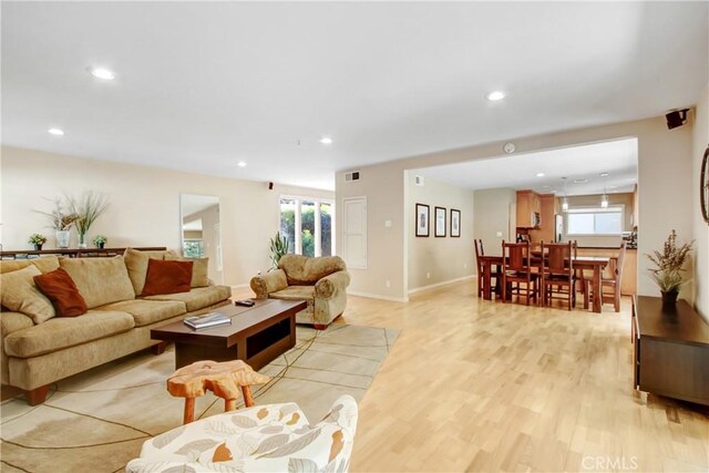 living room with plenty of natural light and light wood-type flooring