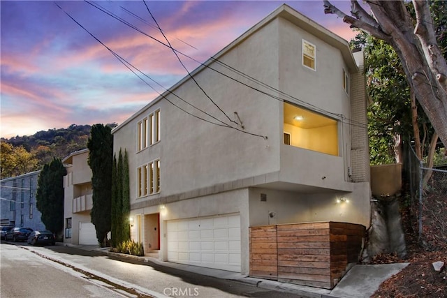 view of front of property with a garage and stucco siding